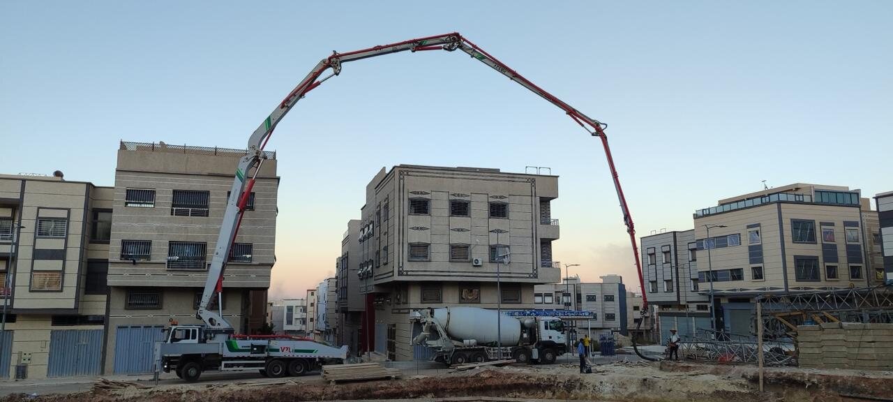 Pompe à béton Néo Béton déployée au-dessus d'un chantier urbain